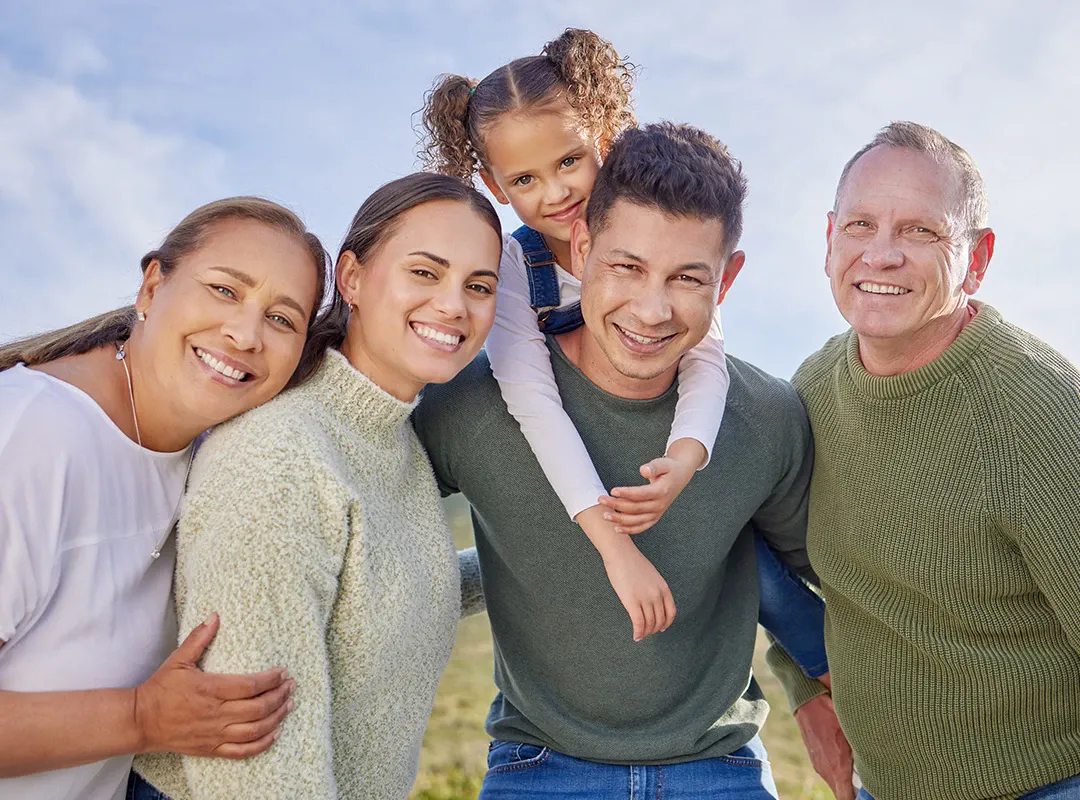 A big, happy family together outdoors